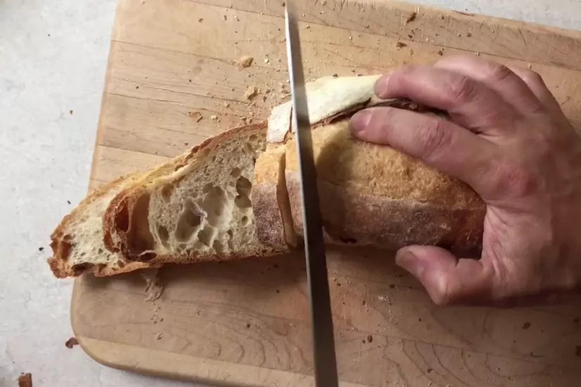 cutting hard bread with a bread knife